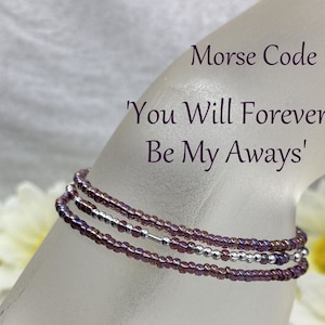 May include: A purple and silver beaded bracelet with the message 'You Will Forever Be My Always' in Morse code.