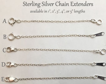 May include: Six sterling silver chain extenders in various lengths, from 1 to 5 inches. Each extender has a different clasp style, including lobster claw, spring ring, and a hook.