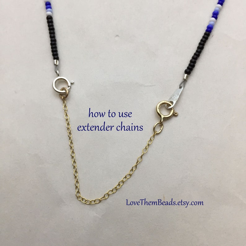 May include: A close-up of a gold extender chain with a silver clasp. The text "how to use extender chains" and "LoveThemBeads.etsy.com" is visible in the image.