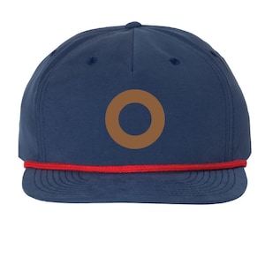May include: A navy blue baseball cap with a red rope trim and a brown circle logo.