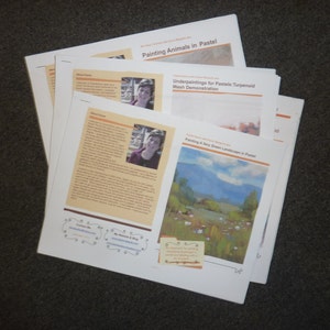 May include: A stack of papers with the title "Painting Animals in Pastel" and "Painting a Very Green Landscape in Pastel". The papers include text and images of a woman and a landscape painting.