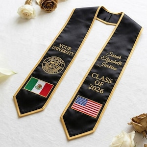May include: Black graduation sash with gold trim and embroidered text. One side features the Mexican flag and the words "YOUR UNIVERSITY". The other side has the American flag and the name "Sarah Elizabeth Jenkins" and "CLASS OF 2026".