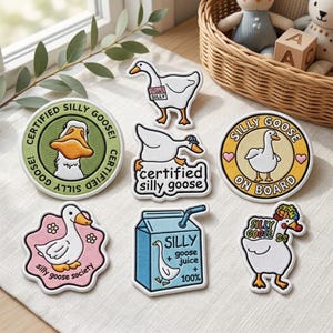 May include: A collection of seven embroidered patches featuring white geese. Designs include a green circular badge, a goose with a name tag, a running goose, a yellow circular sign, a pink flower-shaped patch, a blue juice carton, and a goose with a floral crown.