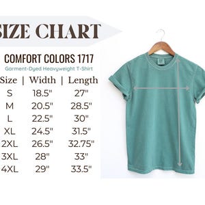 May include: A teal Comfort Colors 1717 garment-dyed heavyweight t-shirt hanging on a wooden hanger. The image includes a size chart with measurements in inches for sizes S through 4XL. The chart lists width and length measurements for each size.