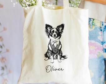 May include: A white canvas tote bag with a black and white illustration of a dog wearing a bow tie. The dog's name, "Oliver", is written in cursive below the illustration.