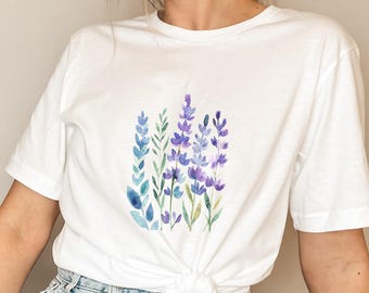 May include: White t-shirt with a watercolor design of purple and blue lavender flowers.