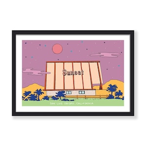 May include: A framed art print featuring a colorful illustration of the Sunset Drive-In in San Luis Obispo, California. The artwork depicts the drive-in under a purple sky with a pink sun, stars, and clouds. The word "Sunset" is displayed on the marquee.