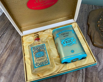 May include: A gift set containing a bottle of 4711 Eau de Cologne and a bar of 4711 Cream Soap. The set is packaged in a gold and blue box with a red and gold label that reads "4711 Aus der Glockengasse".