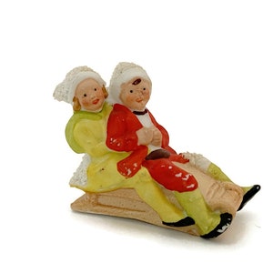 Antique Hertwig German Bisque Porcelain Sledding Figurine