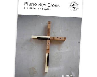 May include: DIY project plans for a wooden cross made from piano keys. The cross is made of light brown wood with black and white piano keys. The plans are titled "Piano Key Cross DIY Project Plans".