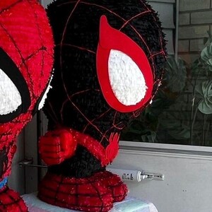 May include: A set of three ceramic mugs with a speckled, matte finish. The mugs are in shades of cream, light gray, and dark gray. Each mug has a simple, minimalist design and a rounded handle.