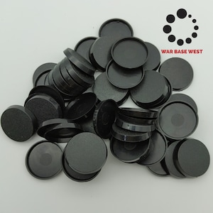 May include: A pile of 30 black plastic round bases for miniature wargaming figures.
