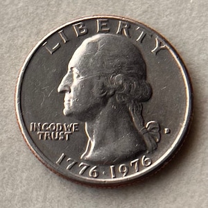 May include: A silver US quarter dollar coin with the image of George Washington on the obverse side. The coin has the inscription "LIBERTY" above the image and "IN GOD WE TRUST" below the image. The date "1776-1976" is inscribed below the image.