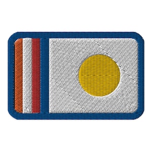 May include: A blue and white embroidered patch with a yellow circle in the center. The patch has three red and orange stripes on the left side.
