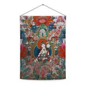 May include: A decorative wall hanging with a detailed illustration of a seated figure within a circular halo, surrounded by colorful flowers. The artwork is dominated by shades of red, blue, and green, with intricate floral patterns throughout.