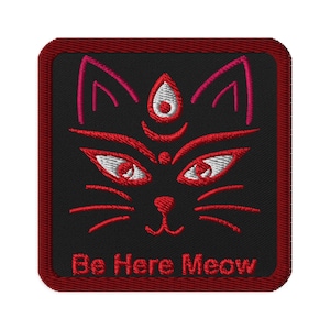 May include: Red and pink embroidered patch with a black cat face and the text "Be Here Meow".
