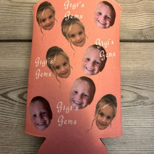 May include: Pink can cooler with multiple photos of children's faces and the text "Gigi's Gems" repeated throughout.