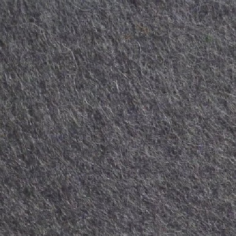 May include: A close-up of a dark gray felt fabric with a textured surface.