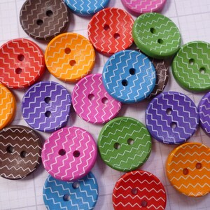 May include: Assortment of colourful wooden buttons with a zig-zag pattern. The buttons are in various colours, including red, orange, yellow, green, blue, purple, and brown.