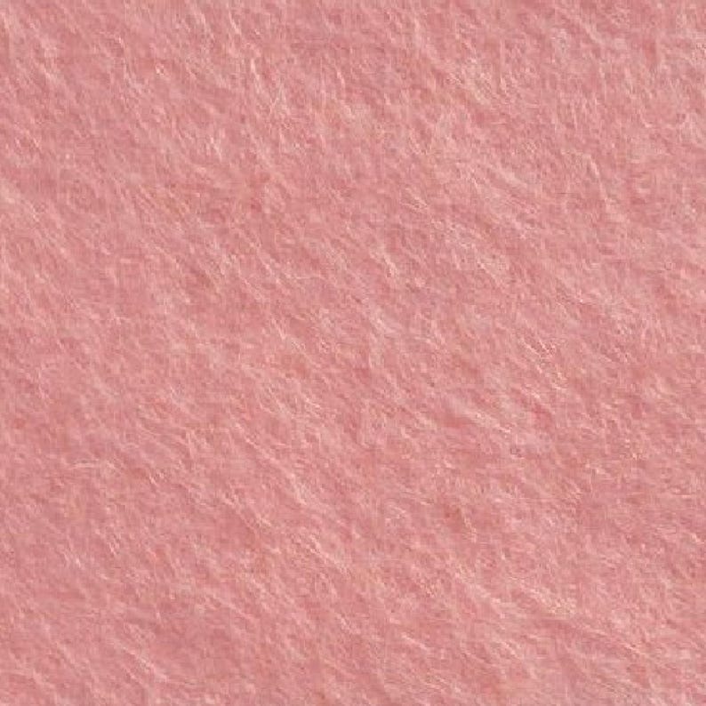 May include: A close-up of a soft, pink felt fabric. The texture is fuzzy and the color is a light, dusty rose.