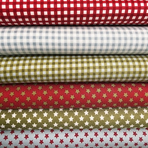 May include: A stack of six folded fabric bolts featuring various patterns. The top three bolts display a classic gingham check in red, light blue, and olive green. The bottom three bolts feature a repeating star print in red, olive, and light blue.