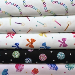 May include: Five stacked bolts of fabric featuring festive patterns. The top layer has colourful chain links on white. The second has candles and stars on white. The third has multi-coloured bows on white. The fourth has disco balls on black. The bottom has gift boxes on white.