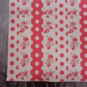 May include: White fabric with a repeating pattern of pink polka dots, pink scalloped edges, and pink floral designs.