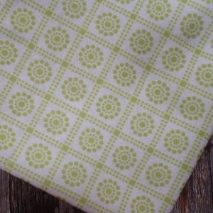 May include: White fabric with a repeating pattern of green circles in a square shape.