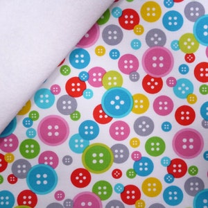 May include: White fabric with a repeating pattern of colourful buttons. The buttons are various shades of red, pink, blue, green, yellow, and grey. Each button has four white stitches.