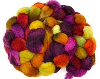 May include: A braided bundle of colorful wool yarn in shades of purple, green, orange, and red.