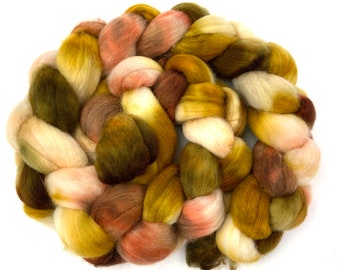 May include: A braided bundle of colorful wool yarn in shades of brown, green, yellow, and pink.