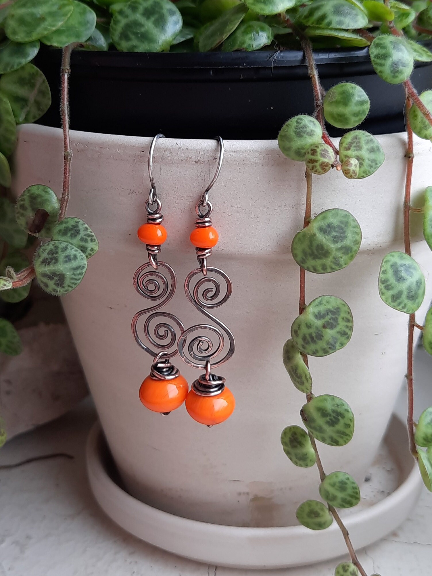Copper spiral earrings with burnt orange czech glass beads and sterling silver ear wires