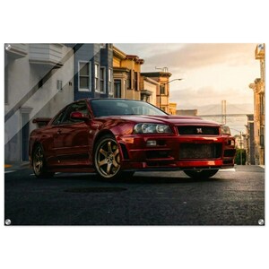 Könnte beinhalten: Ein roter Sportwagen steht auf einer Stadtstraße. Das Auto hat ein schlankes Design mit goldfarbenen Felgen. Der Hintergrund zeigt Gebäude und eine Brücke unter einem Sonnenuntergangshimmel. Der Kühlergrill des Autos hat die Buchstaben "R" und "B".