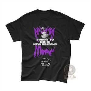 May include: Black t-shirt featuring purple text: "I WANT TO DIE IN NEW ORLEANS" and "SUICIDEBOYS IS THIS OUR GRAVE?". The design incorporates a graphic illustration and the brand logo.