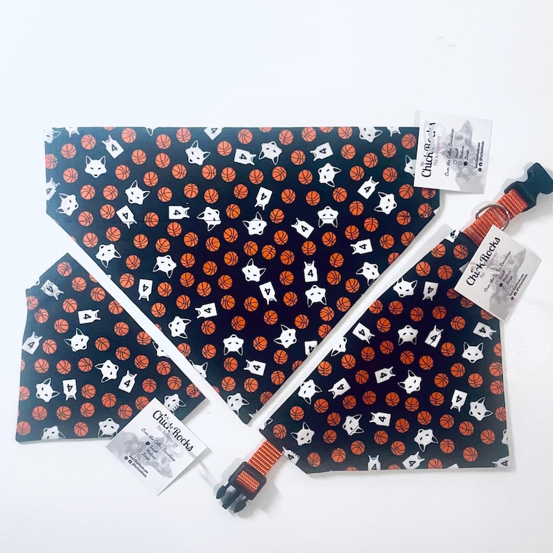 May include: A set of pet bandanas and a collar featuring a dark blue background with a repeating pattern of orange basketballs, white fox faces, and white jerseys with the number 4. Each item includes a white tag labeled Chick Rocks.