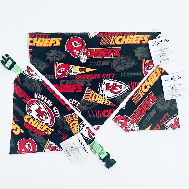 May include: A black pet bandana and collar set with a repeating pattern of the Kansas City Chiefs logo, helmets, and text in red, yellow, and white. The collar is green with a black buckle.