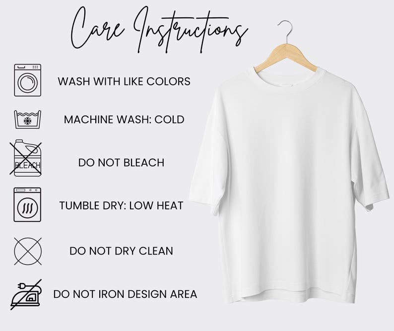 May include: A white t-shirt hangs on a wooden hanger. The shirt is plain and has short sleeves. To the left are care instructions with icons and text: Wash with like colors, machine wash cold, do not bleach, tumble dry low heat, do not dry clean, and do not iron design area.