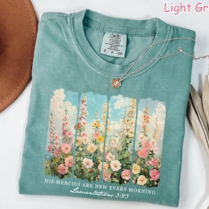 May include: Light green t-shirt with a vintage floral print and the text "HIS MERCIES ARE NEW EVERY MORNING Lamentations 3:23".