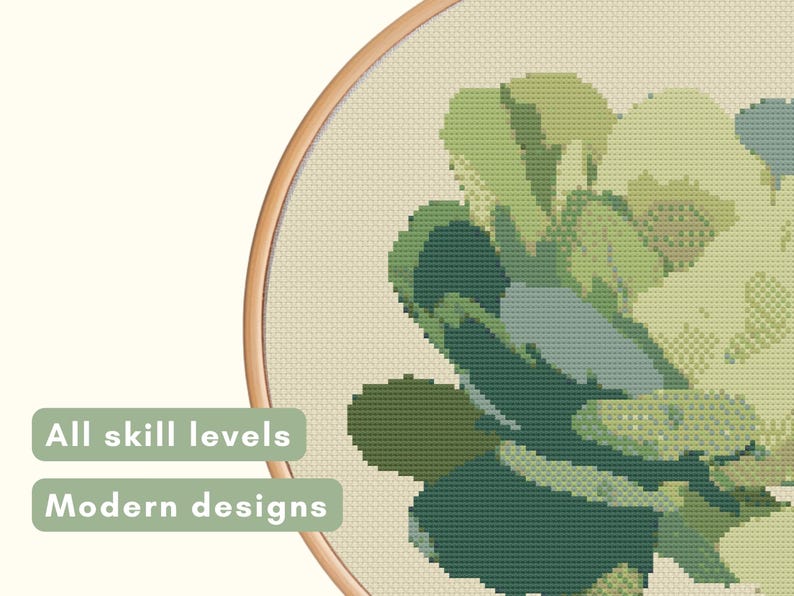 May include: Cross-stitch embroidery of a succulent plant in shades of green, blue, and beige, set within a wooden hoop. The text "All skill levels" and "Modern designs" are displayed on the left side.