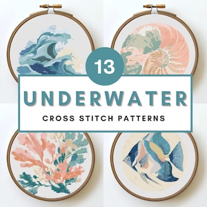 May include: A collection of 13 "Underwater Cross Stitch Patterns" displayed in wooden embroidery hoops. The designs feature ocean waves, a nautilus shell, coral, and a fish, all in shades of blue, green, and coral.