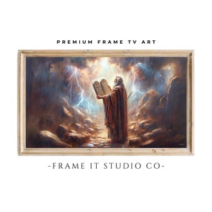 May include: A painting of a man holding two stone tablets with text on them. He is standing on a rocky path with lightning in the background. The painting is framed in a light wood frame.