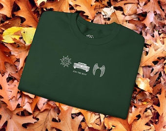 May include: A dark green t-shirt with a white graphic design featuring a sun, a car, and angel wings. The text "Join the Hunt" is printed below the graphic.