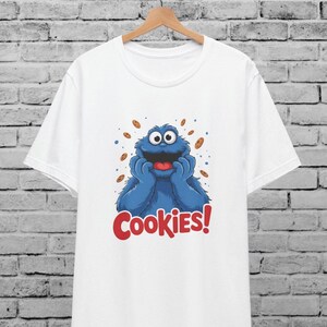 Camiseta unisex multicolor del Monstruo Comegalletas para hombre y mujer, Barrio Sésamo, TV retro vintage, regalo divertido, fans de los Muppets, camiseta gráfica divertida.