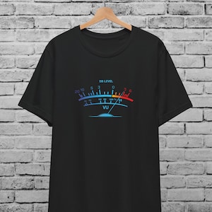 May include: Black t-shirt with a graphic of a VU meter. The meter has a blue and red gradient with the text "DB LEVEL" above it and "VU" below. The meter's scale ranges from 20 to 100.