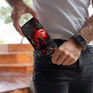 May include: A black phone case with a black cat silhouette against a red moon and a dark forest background.