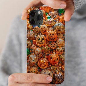 May include: A phone case with a Halloween theme featuring a close-up of many glittery, gold-colored jack-o'-lanterns.
