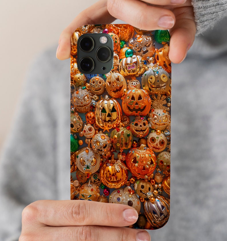 May include: A phone case with a Halloween theme featuring a close-up of many glittery, gold-colored jack-o'-lanterns.