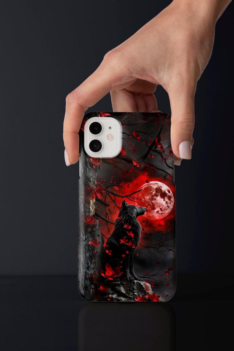 May include: Black wolf silhouette phone case with a red moon and red leaves on a black background.