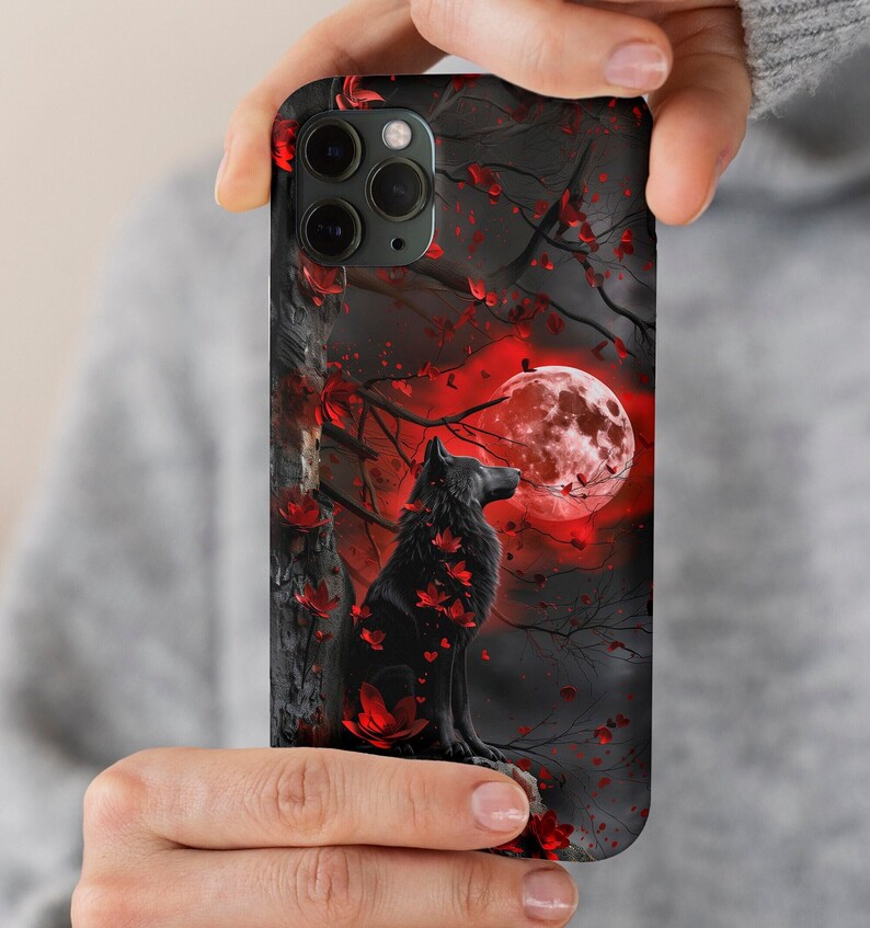 May include: A black wolf silhouette stands in a dark forest with red leaves and a large red moon in the background. The wolf is looking up at the moon.
