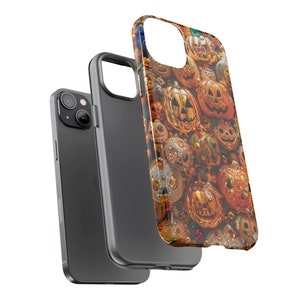 May include: A black phone case with a design of gold and orange jack-o'-lantern faces. The case is shown with a black phone inside.